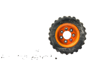 A bright orange toy truck tire on a ruler measures the cracked surface below it during midday isolated on transparent background