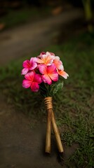 Vibrant Pink and Orange Plumeria Flower Bouquet on Ground