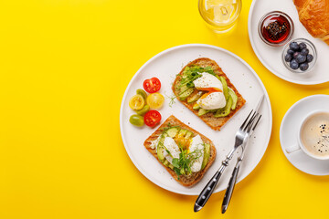 Breakfast with delicious avocado toasts and crispy croissant