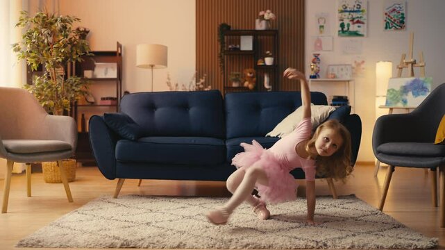 Cute little girl dancing at home, practicing routine for acrobatics hobby