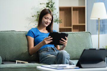 Happy woman entrepreneur working online at home office. Using a laptop for business, searching, and...