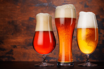 A selection of various beer glasses filled with different types of beer