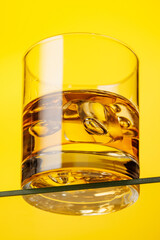 A classic whiskey glass filled with golden amber whiskey
