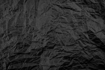Black crumpled paper texture pattern. Rough grunge old blank.