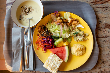 Helsinki, Finland A cafeteria tray with salad, bread, watermelon, hummus and soup.