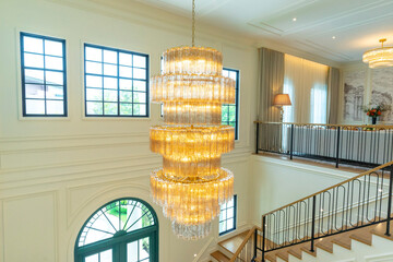 An elaborate, crystal chandelier in a hotel lobby or luxury home.