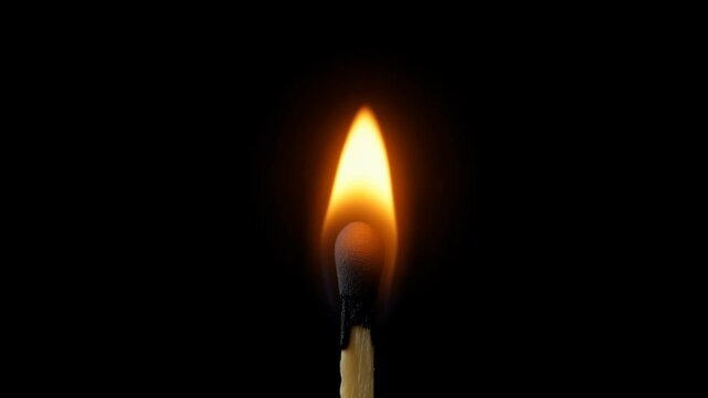 Close-Up of a Single Matchstick Igniting With a Gentle Flare on a Dark Background