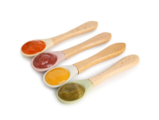 Baby food. Spoons with tasty puree on white background