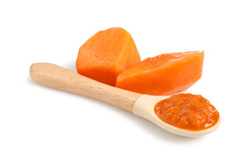 Baby food. Tasty puree in spoon and persimmon isolated on white