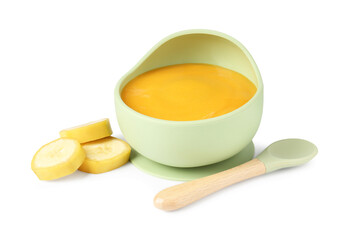 Baby food. Tasty puree in bowl, banana and spoon isolated on white