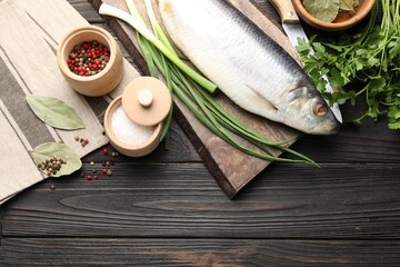 Tasty herring with spices on wooden table, flat lay