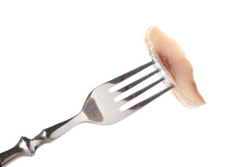 Piece of delicious herring on fork against white background