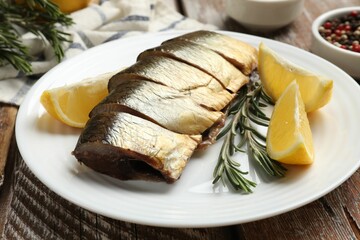 Smoked herring and spices on wooden table, closeup