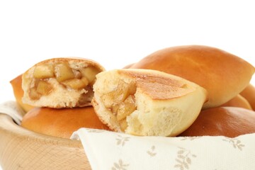 Tasty baked patties with apples in wooden bowl on white background, closeup