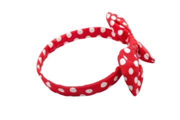 Charming red polka dot headband with a playful bow resting against a pristine white backdrop isolated on transparent background