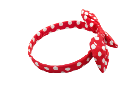 Charming red polka dot headband with a playful bow resting against a pristine white backdrop isolated on transparent background