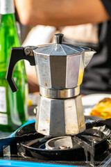 Making coffee with a Moka Pot outdoors.