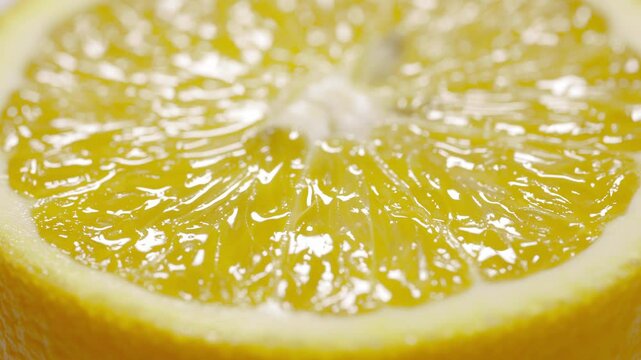 Marco shot a lemon and turned it. Citrus fruit. Close-up of lemon pulp. Lemon slices. Fruit background.