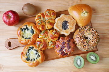 Mouthwatering assorted savory and dessert breads on a wooden breadboard