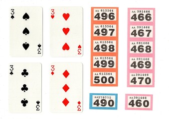 Vintage playing cards and raffle tickets isolated on a white background.
