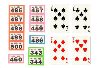 Vintage playing cards and raffle tickets isolated on a white background.