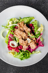 Tuna salad canned fish mixed green leaf lettuce seafood appetizer vegetable dish organic fresh tasty gourmet food background on the table rustic top view copy space vegetarian food pescetarian diet
