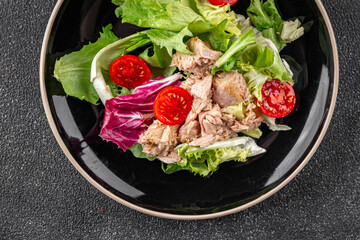 Tuna salad canned fish mixed green leaf lettuce seafood appetizer vegetable dish organic fresh tasty gourmet food background on the table rustic top view copy space vegetarian food pescetarian diet