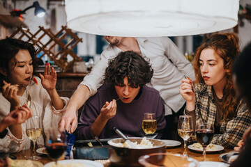 Friends dining together at a cheerful gathering, sharing moments, food, and beverages around a beautifully set table, creating lasting memories and enjoying each others company in a warm atmosphere.