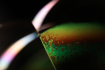 Green liquid surface, green Reflections of liquid in macro,, bubbles in macro, connection of bubbles in macro, cell from liquid, dark background, glossy surface