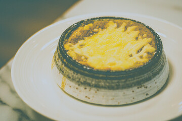 Fresh Onion Soup with caramelized onions, savoury beef stock, brioche bread and emmental cheese.