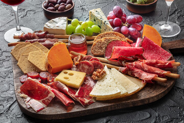 Antipasti or tapas. Charcuterie and cheese board with wine, fruit, bread. Spanish and Italian...