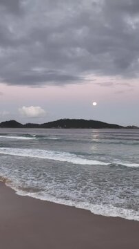 Moonrise in Campeche, Florianopolis, Brazil. Aerial view, vertical video.
