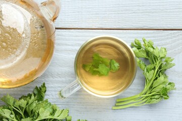Healthy parsley tea on grey wooden table, flat lay. Detox drink