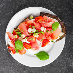 Bruschetta ham, tomato, greens dish fresh delicious gourmet food background on the table rustic food top view copy space