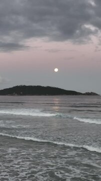 Moonrise in Campeche, Florianopolis, Brazil. Aerial view, vertical video.