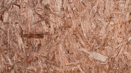 The texture of the OSB material, the recycled pressed wood chips, the texture of plywood. close up