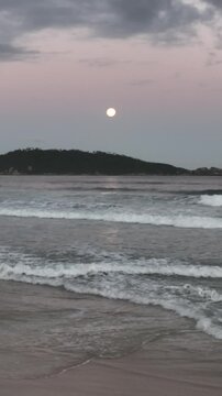 Moonrise in Campeche, Florianopolis, Brazil. Aerial view, vertical video.