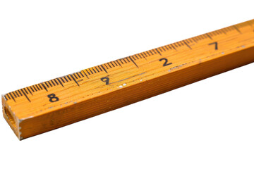 A close-up view of a well-used yellow wooden ruler on a bright white surface isolated on transparent background
