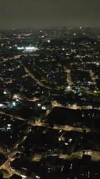 Itaquera neighborhood in S&atilde;o Paulo at night. Aerial view. Vertical video.