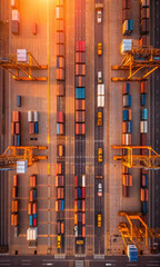 Obraz premium Aerial view of busy cargo terminal with colorful shipping containers and cranes, showcasing logistics industry