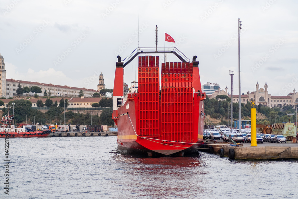 Aufkleber large red ferry docked along the bosphorus with cityscape and historic structures in the background 
