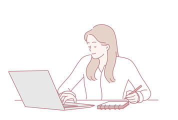 A dedicated woman works hard on her laptop, taking detailed notes and showcasing impressive productivity and focus