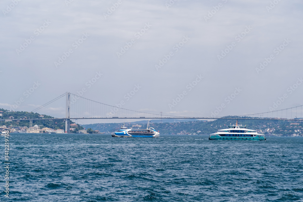 Aufkleber Bosphorus ferry boats navigate the waters with a bridge in the background during a cloudy day in Istanbul