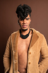 Stylish model posing with open fur coat and unique necklace