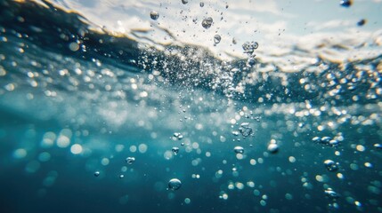 Air bubbles rising underwater in the ocean to the surface