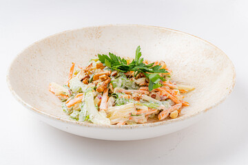 Vibrant salad features crunchy vegetables topped with nuts and fresh herbs in a beautiful bowl