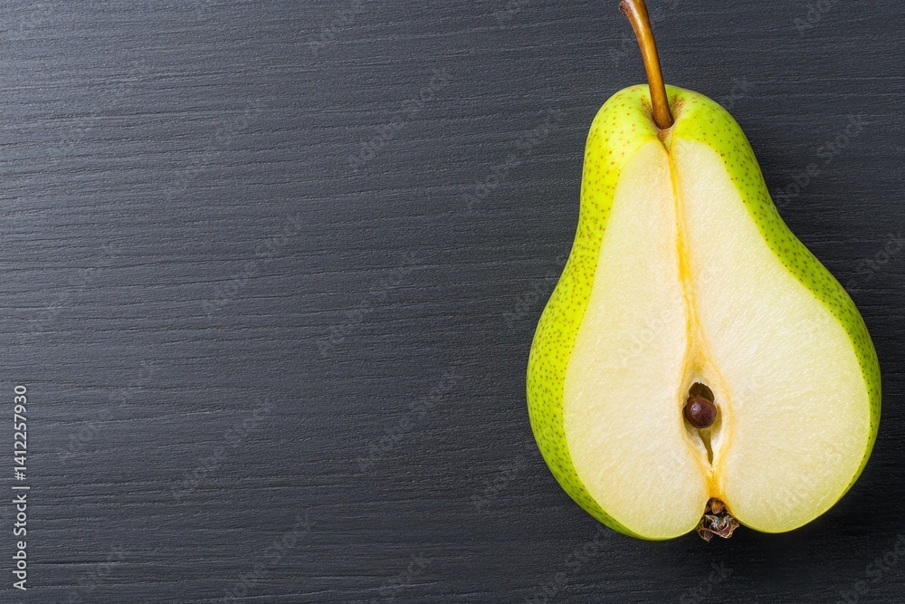 Poster a sliced pear showing its delicate seed core, set against a dark rustic background