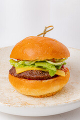 Mouthwatering burger features a succulent patty, crisp lettuce, and creamy cheese on a golden bun