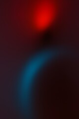 An abstract composition with blurred red and blue gradients colors and shapes, creating a sense of motion.