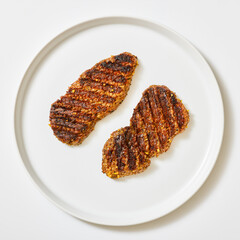 spicy tenderized beef cutlets on white background